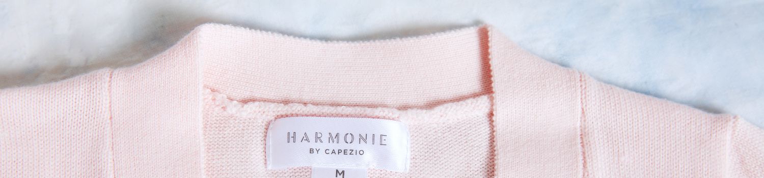 A Pink Sweater With A Label